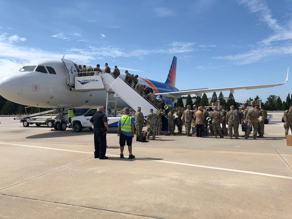 Military troops boarding a flight at from the GSP airport ramp